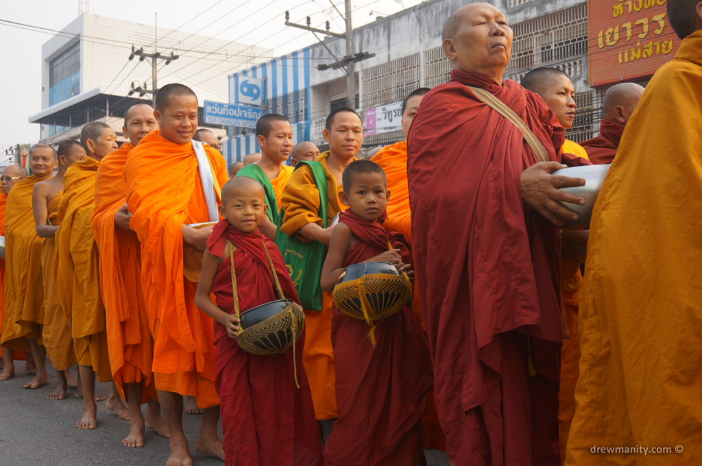 monks waiting in like for alms