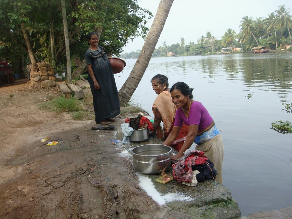 Women doing laundry in Kerala India backwater  cannals
